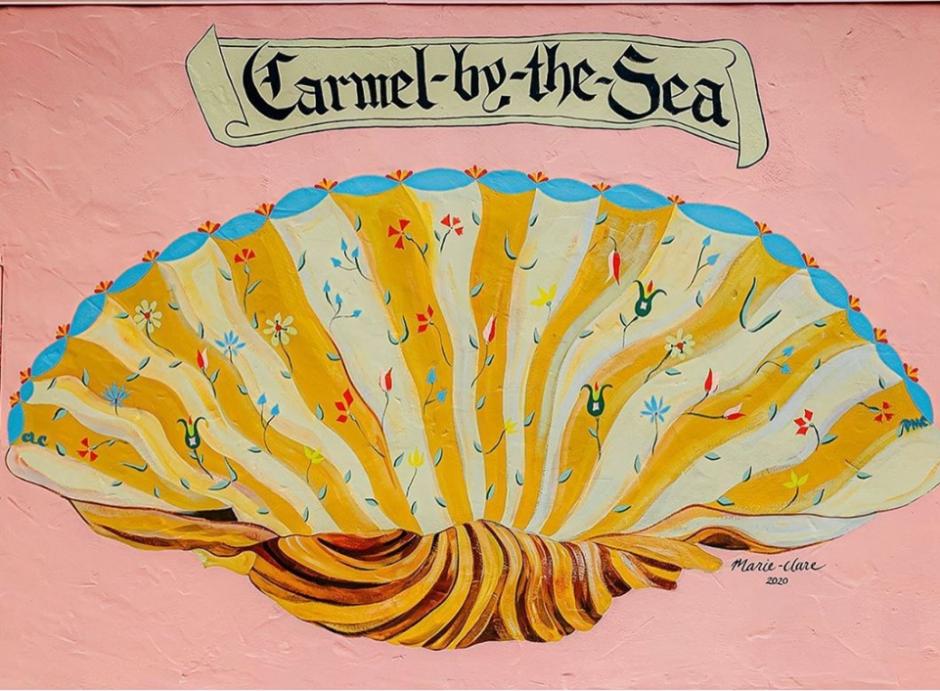 Large mural of a clamshell with floral motifs on a pink background.