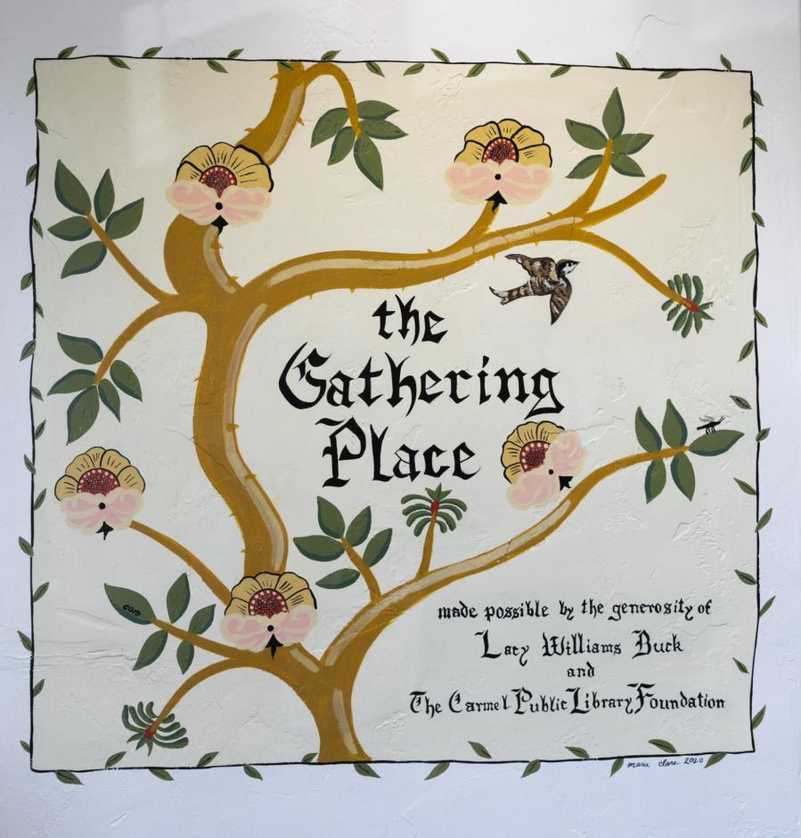 Hand-painted sign in the library that says "The Gathering Place, made possible by the generosity of Lacy Buck Williams and the Carmel Public Library Foundation," surrounded by painted flowering vines