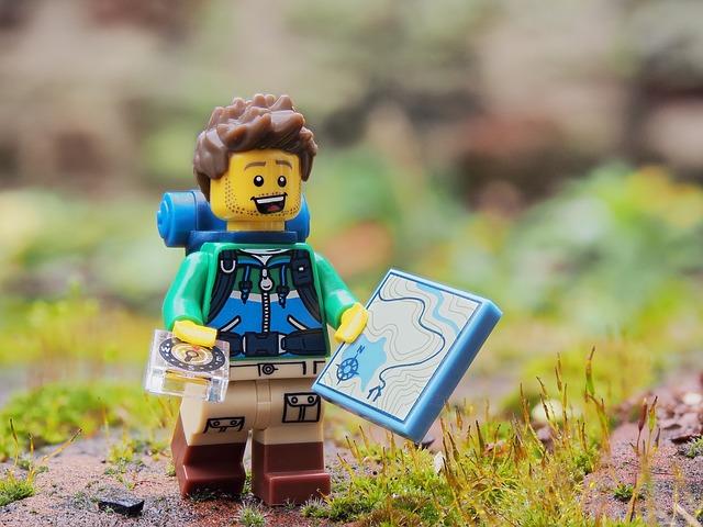 Lego figurine of a hiker holding a map.